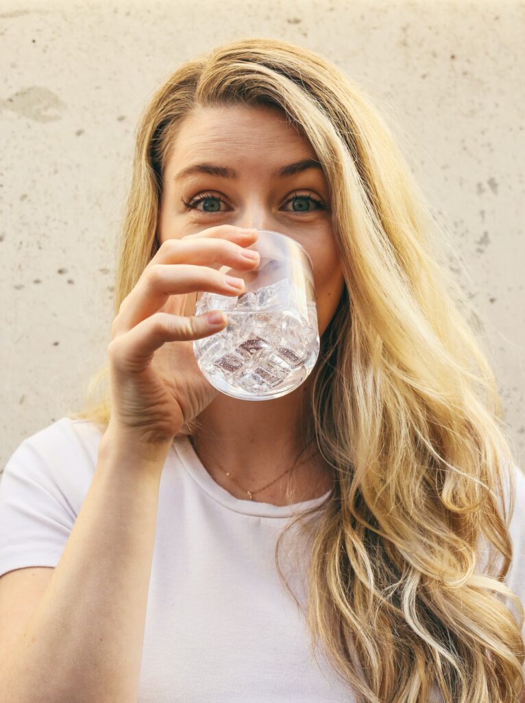 a women drinking a glass of water